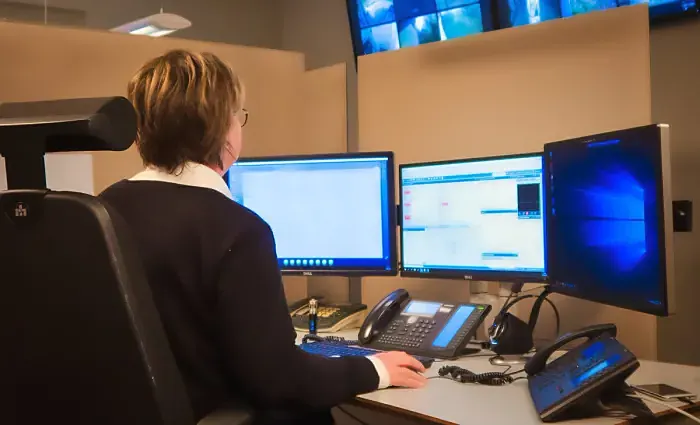 Operatør ved skjermer i døgnbemannet alarmsentral